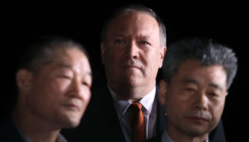 Secretary of State Mike Pompeo stands with tKim Dong Chul and Kim Hak-song