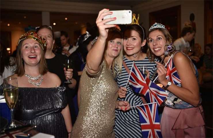 Fans take a selfie as they watch a live screening of the wedding in Sydney