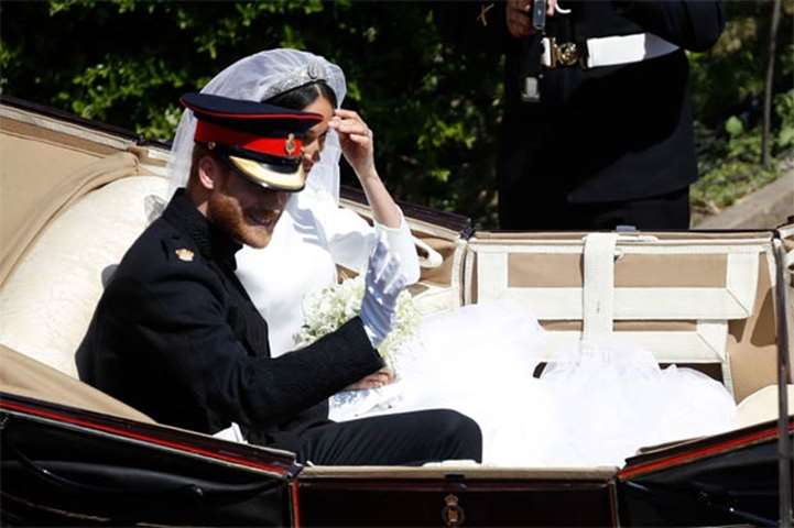 Prince Harry and his wife Meghan begin their carriage procession after their wedding ceremony