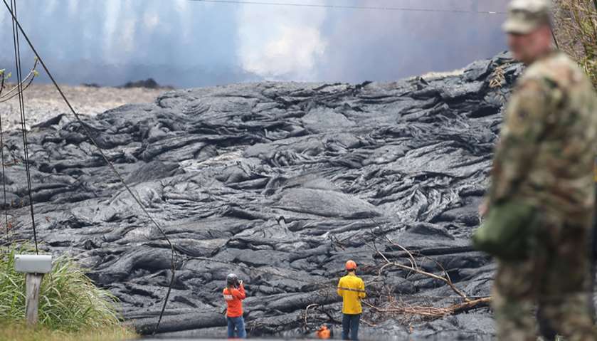 USGS workers observe lava from a Kilauea volcano fissure in Leilani Estates, on Hawaii\'s Big Island