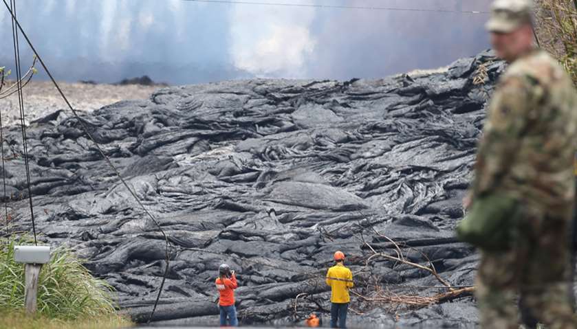 USGS workers observe lava from a Kilauea volcano fissure in Leilani Estates, on Hawaii\'s Big Island