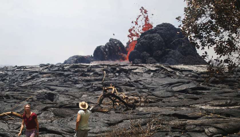 People gather as lava erupts from a Kilauea volcano fissure in Leilani Estates, on Hawaii\'s Big Isla