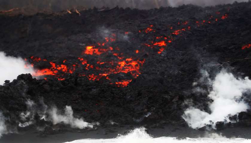 After crossing Highway 137, lava pours into the ocean during the eruption of the Kilauea Volcano nea