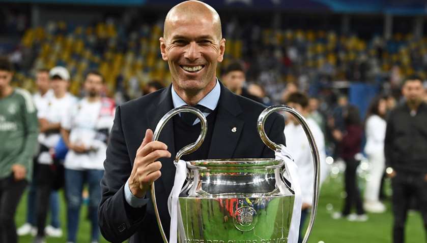 Real Madrid\'s French coach Zinedine Zidane holds the UEFA  trophy