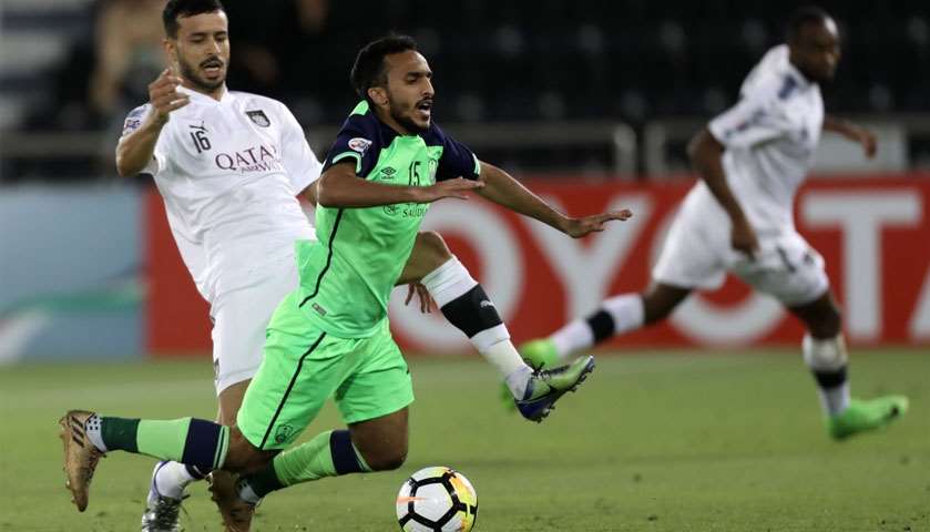 Al-Sadd\'s Boualem Khaoukhi (L) tackles Al-Ahli\'s forward Saleh Al-Amri