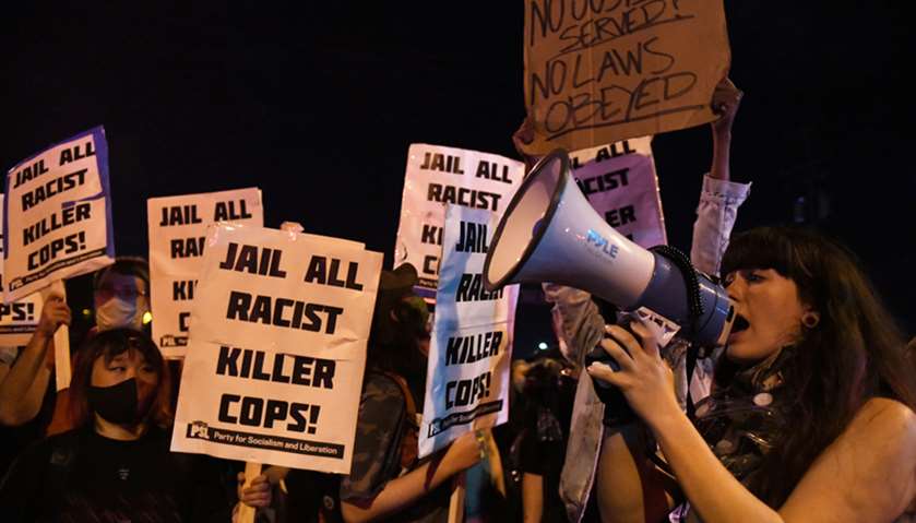 Demonstrators chant outside the fifth police precinct during the fourth day of protests