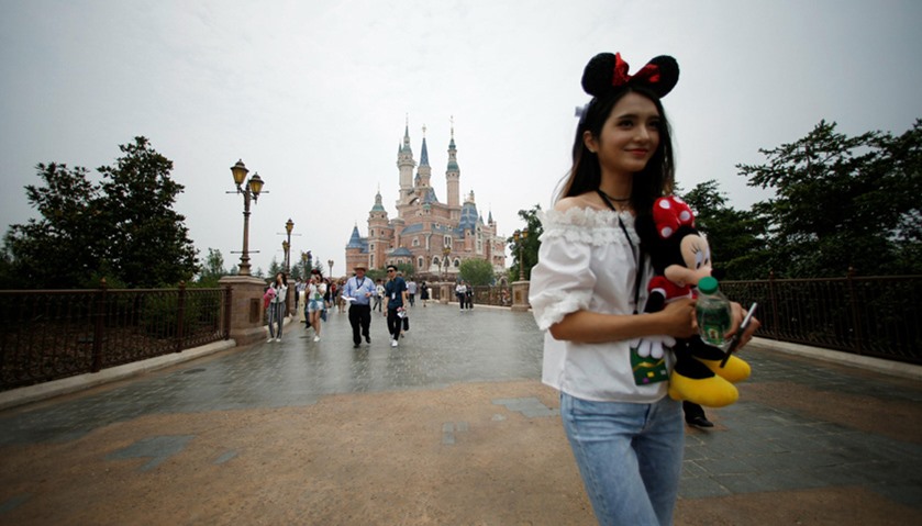 People walk at Shanghai Disney Resort during a three-day Grand Opening event in Shanghai, China
