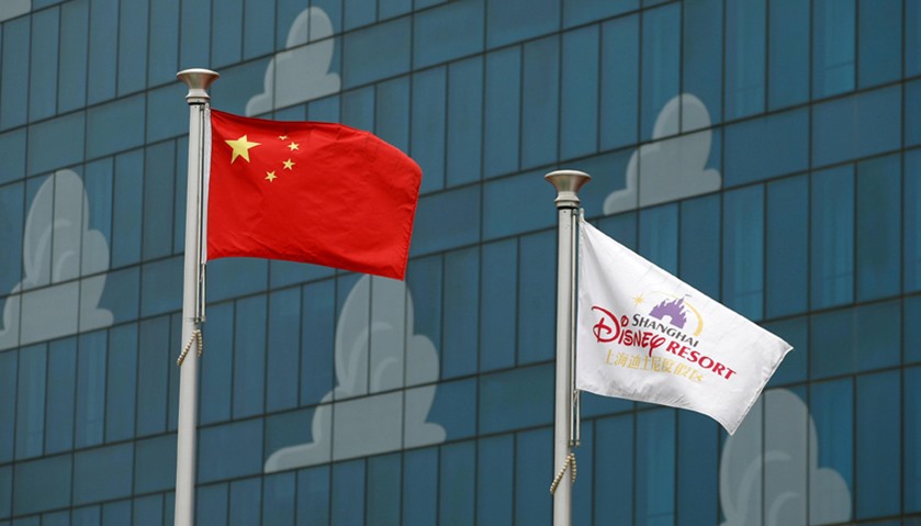 Chinese (L) and Disney flags are seen at Shanghai Disney Resort