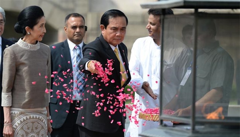 Prayut Chan-O-Cha sprinkles rose petals while paying tribute to Mahatma Gandhi at Rajghat memorial