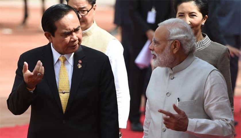 Prayut Chan-O-Cha talks with Narendra Modi after inspecting a guard of honour in New Delhi on Friday
