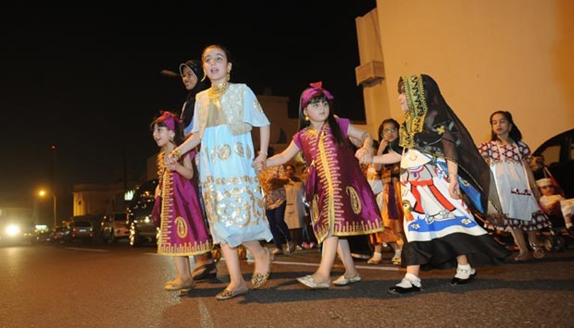 During Garangao, children dress up in special clothes and carry a bag around their neck