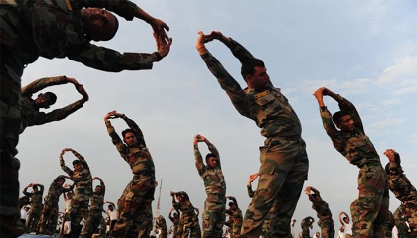 Indian Army soldiers stretch and bend in a yoga demonstration in Chennai on Tuesday