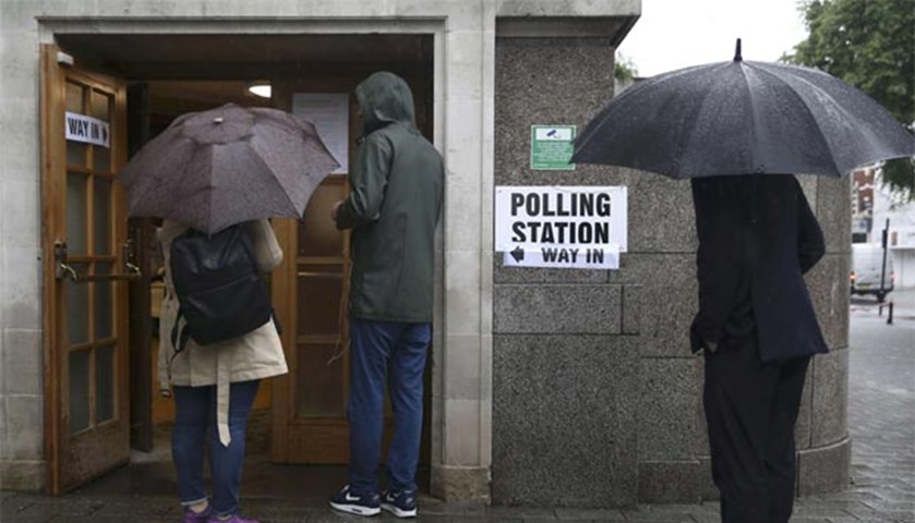 People queue outside a polling station for the referendum on the European Union in north London