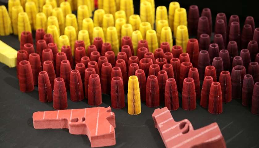 Paper sculptures in the shape of handguns and bullets