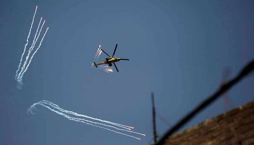An Iraqi Army helicopter launches decoy flares over western Mosul