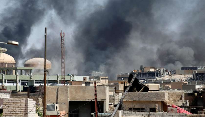 Smoke caused by clashes between the Iraqi forces and Islamic State militants is seen in Mosul