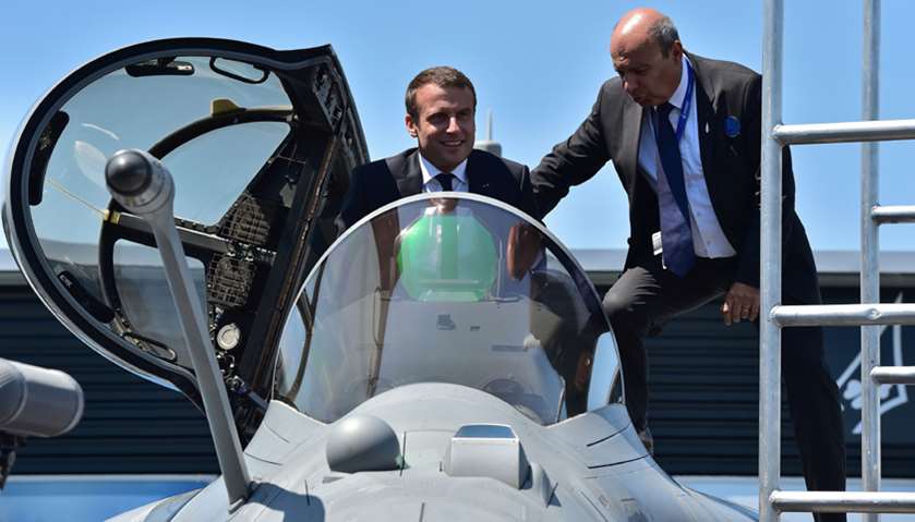 France\'s President Emmanuel Macron (L) sits in a Dassault Aviation Rafale fighter jet as Dassault Av