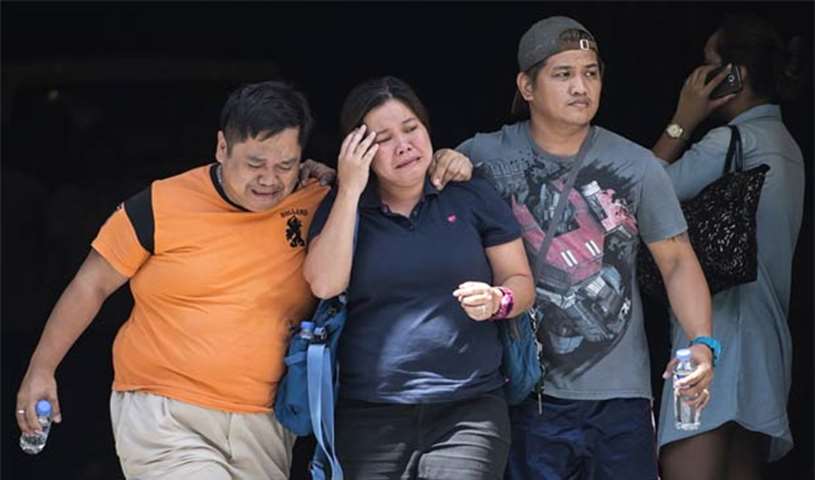 Relatives of a victim cry outside the Resorts World Hotel in Manila