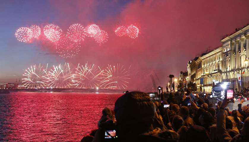 People watch fireworks over the Neva River during the Scarlet Sails festivities marking school gradu