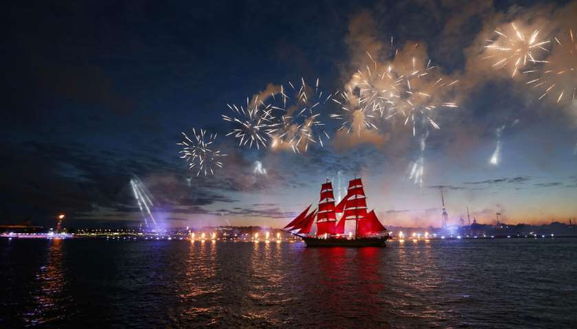 Fireworks explode over Sweden\'s brig Tre Kronor with scarlet sails which floats on the Neva River