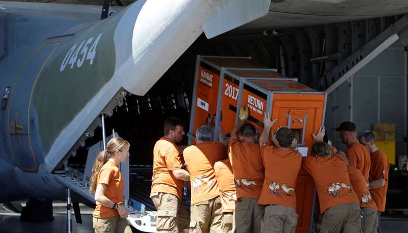 Zoo workers load a container with a Dzungarian horse into a military airplane, Kbely Airport, Prague