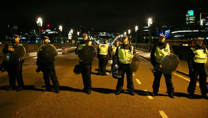 Police officers guard the approach to Southwark Bridge after an incident near London Bridge