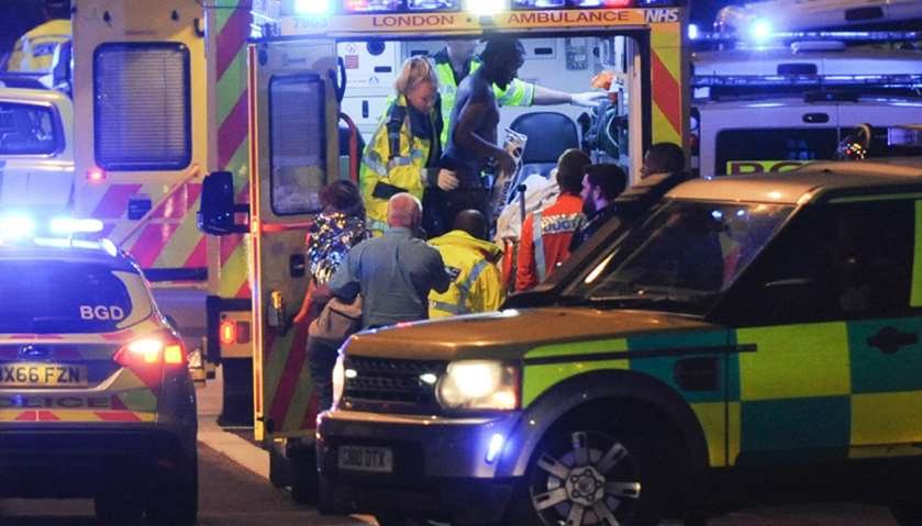 Members of the emergency services attend to victims of a terror attack on London Bridge