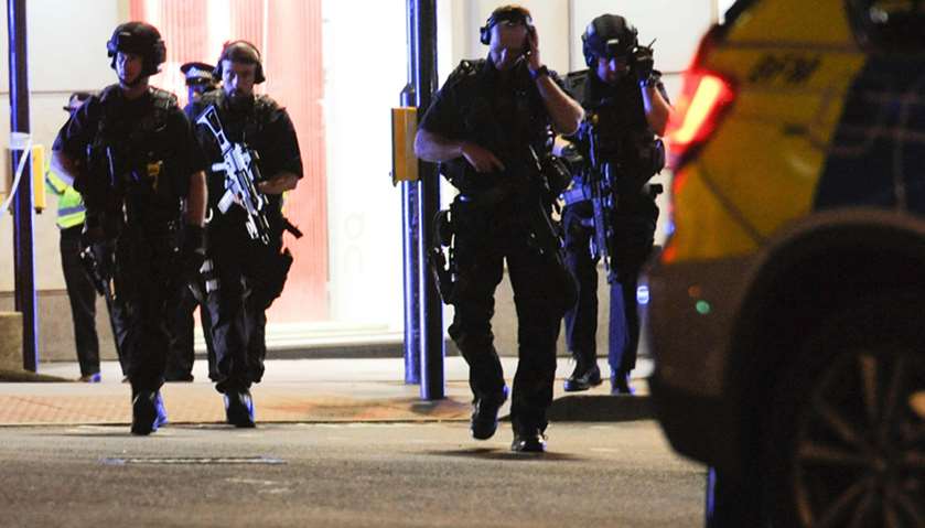 Armed police take position at the scene of a terror attack on London Bridge