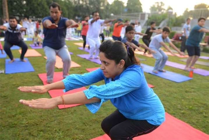 Indians bend during a yoga session at a park in Amritsar on Wednesday