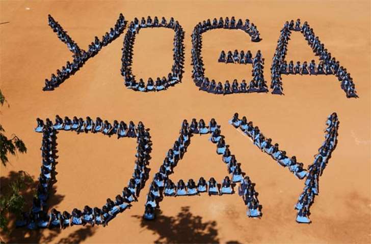 School children form the word ‘Yoga Day’ on the International Yoga Day in Chennai on Thursday
