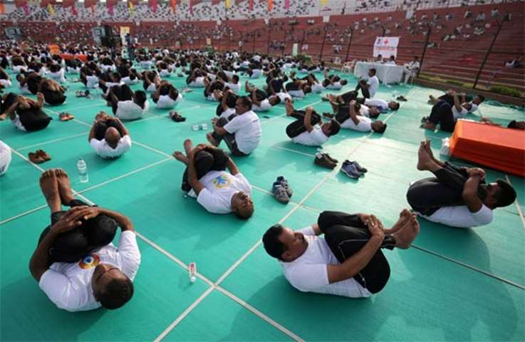 Indian paramilitary soldiers perform yoga at a stadium in Ahmedabad on Thursday
