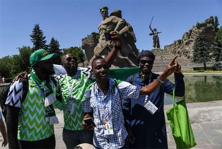 Nigerian supporters react while visiting a memorial complex in Volgograd