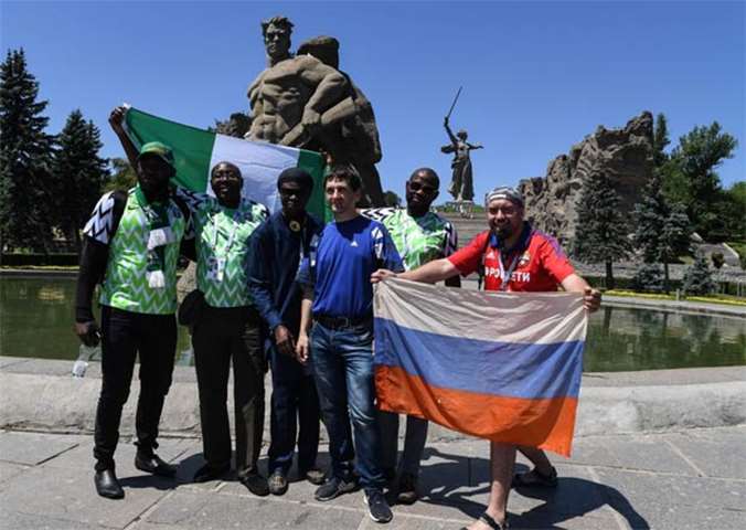 Nigerian supporters pose with Russian fans while visiting the Mamayev Kurgan memorial complex