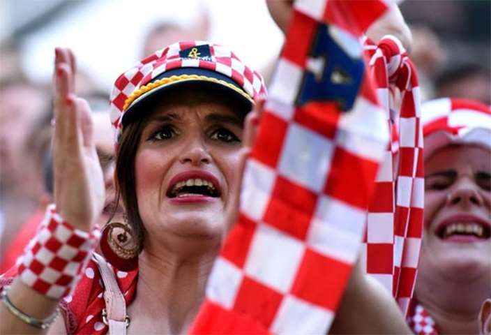 A Croatia fan reacts as she watches the match against Argentina on a giant screen in Zagreb