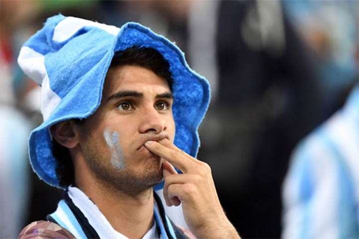 An Argentina fan reacts after his team was defeated by Croatia