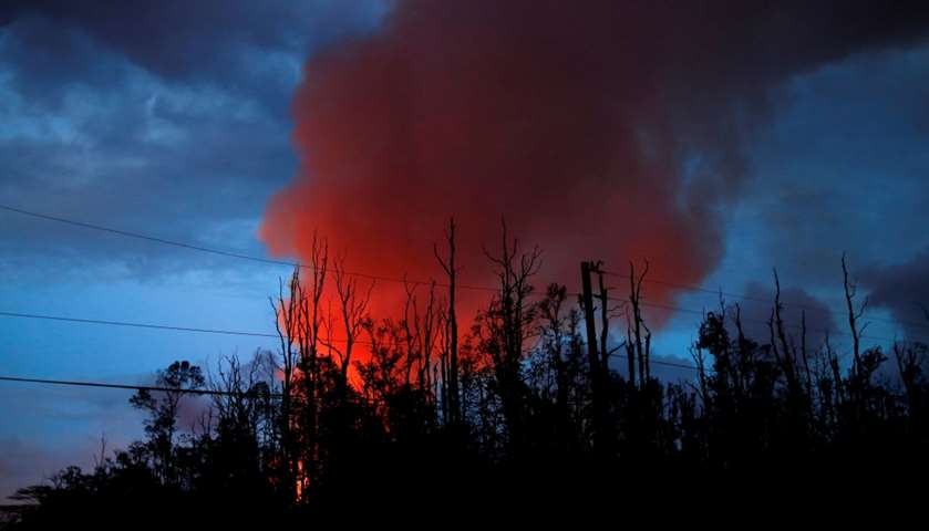 A plume of volcanic emissions rises from a lava fountain - the Kilauea Volcano