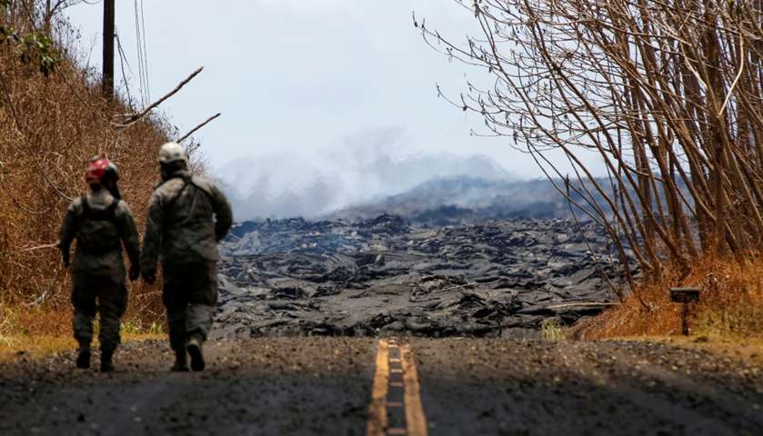 Soldiers from Hawaii National Guard monitor sulfur dioxide gas levels near a lava flow from the Kila