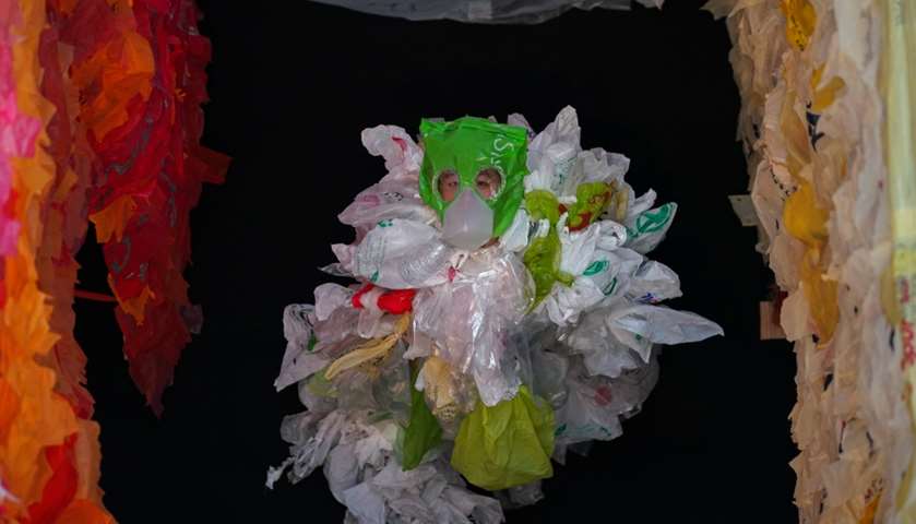 A student dressed as a plastic bag monster poses inside the art installation \" - Bangkok, Thailand