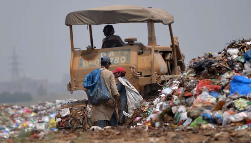 Rag-pickers collect recyclable materials at a garbage dump - Islamabad, Pakistan