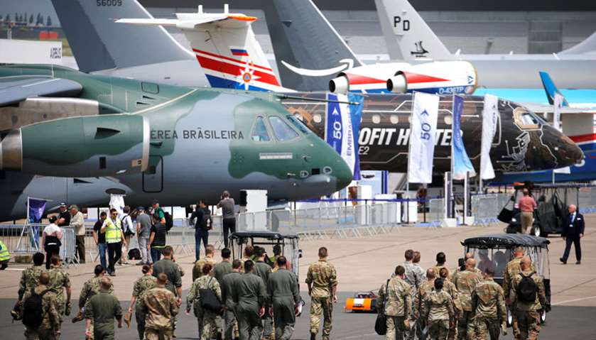 Soldiers walk past aircrafts  at the eve of the opening of the 53rd International Paris Air Show