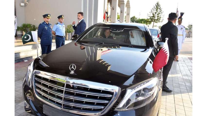 His Highness the Amir Sheikh Tamim bin Hamad al-Thani looks on as PM Imran Khan takes the wheel