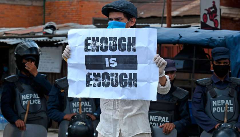 A protester holds a placard during a demonstration against the government