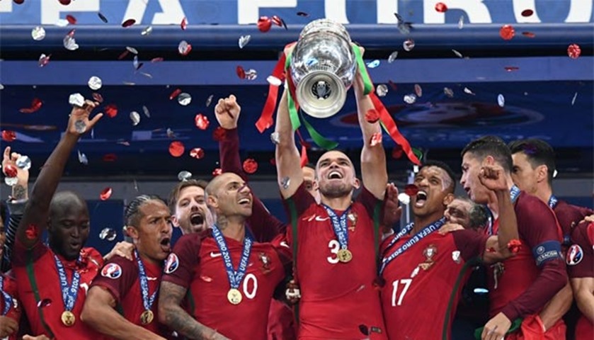 Portugal\'s defender Pepe holds up the winners\' trophy following their triumph in Euro 2016