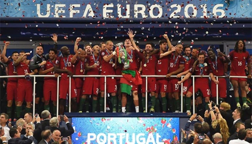 Portugal players pose with the trophy as they celebrate after beating France in the Euro 2016 final