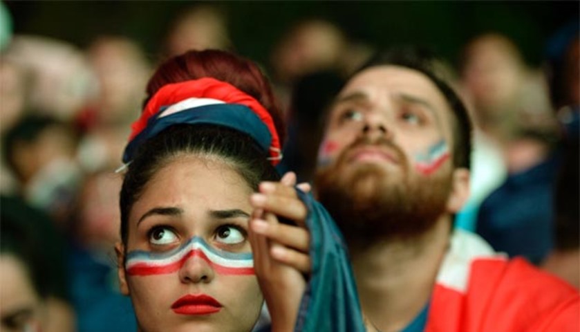 A French supporter reacts after the Euro 2016 final at the Champ-de-Mars fan zone in Paris