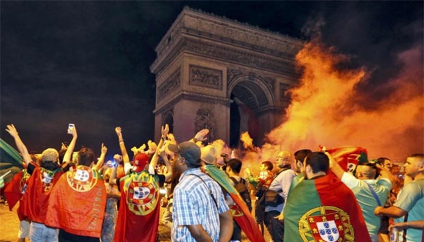 Fans celebrate Portugal\'s Euro 2016 win near the Arc de Triomphe in Paris early Monday