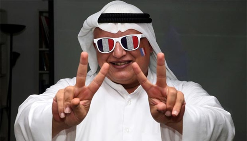 A French supporter in Kuwait City flashes the sign for victory as he watches the Euro 2016 final