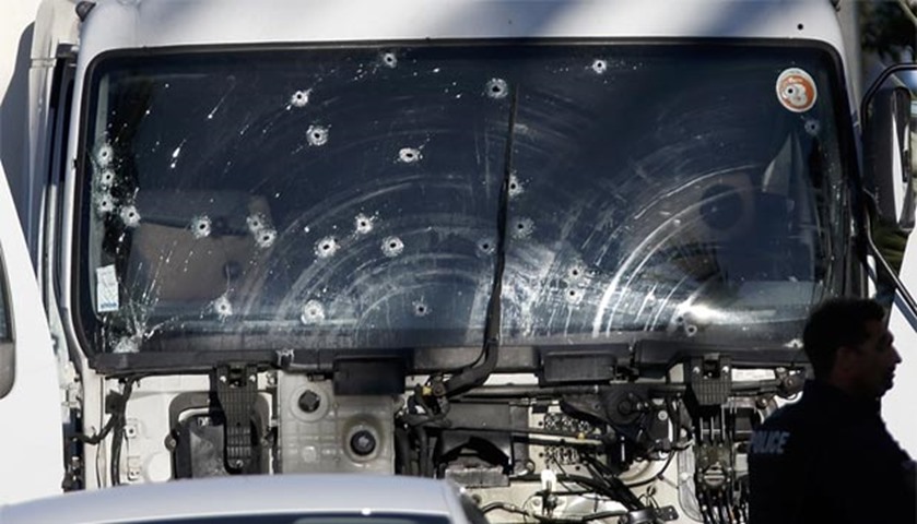 Bullet impacts are seen on the heavy truck the day after it ran into a crowd at high speed in Nice