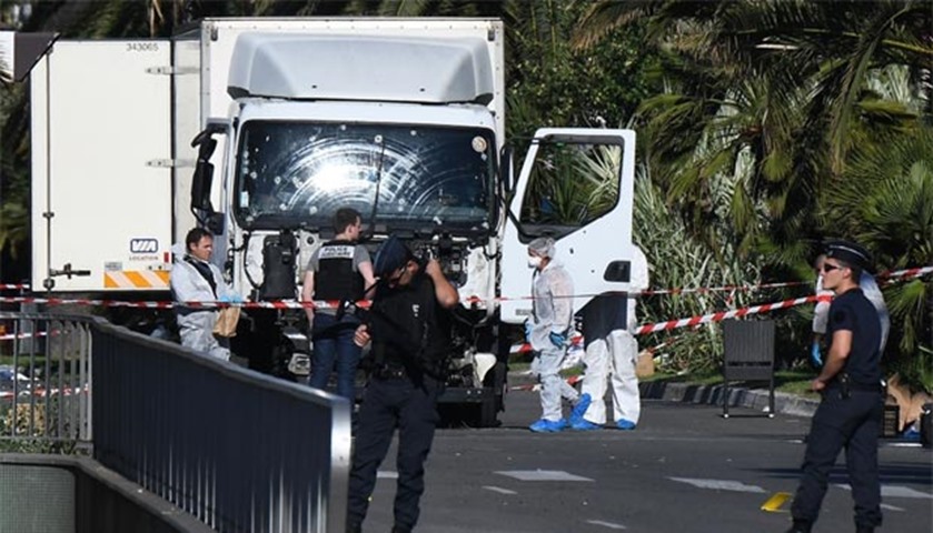 Forensics officers and policemen look for evidences in a truck on the Promenade des Anglais seafront