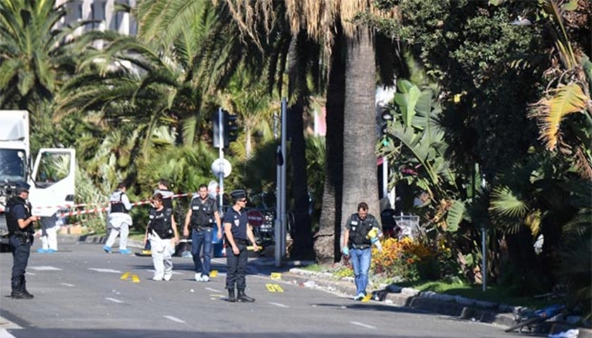 Forensic officers and police look for evidences near a truck on the Promenade des Anglais seafront